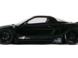 the black sports car is parked on a white surface