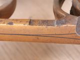 a close up of a metal object on a wooden table