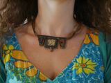 a woman that is wearing a necklace with flowers on it