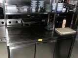 a large kitchen with a lot of dishes on the counter