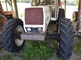 a tractor that is parked under a tent