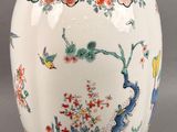 a white vase with a floral design on it