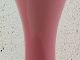 a pink table lamp that is on a black base