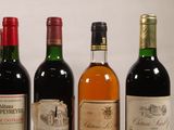 several bottles of wine are lined up in a row on a table
