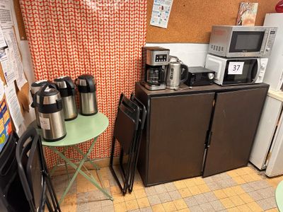a small kitchen with a lot of appliances and a table
