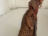 a figurine of a woman in a dress and hat