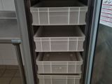 an image of a refrigerator with baskets in it