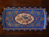 a blue tray with a bird on it on a wooden table