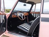 a pink car with black and white stripes and a steering wheel