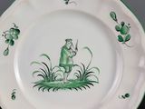 three plates with green and white designs on them