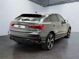 the rear end of a silver audi suv parked in a garage