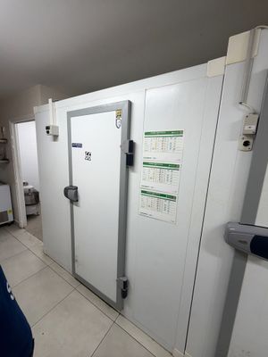 a man that is standing in front of a white door