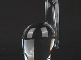 a clear glass vase sitting on top of a table next to a black background