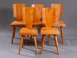 four wooden chairs sitting on top of each other on a gray surface
