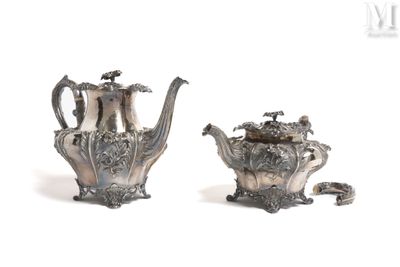 pair of silver plated teapots with handles and handles