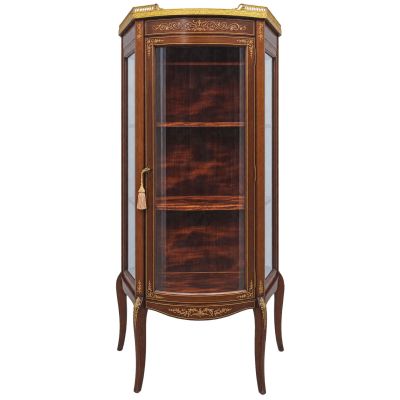 une armoire d'angle en bois avec une porte vitrée et des moulures dorées