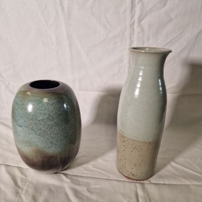 two vases sitting next to each other on a table