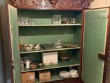 a cabinet with a green door in a kitchen