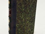 an old book with a brown cover and a green cover