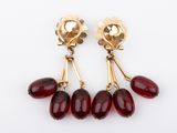 an image of a pair of earrings with red glass beads