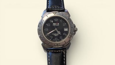 a close up of a watch on a white surface