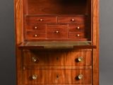 a wooden cabinet with drawers and a marble top