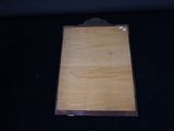 a picture of a wooden plaque on a black surface