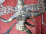 a bronze statue of a woman holding a sword