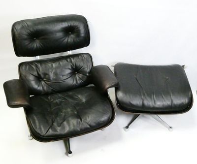 a black leather chair and ottoman on a white background