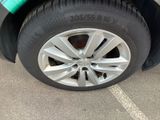 a close up of a tire on a car in a parking lot