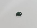 a green tourmaline gems stone on a white surface