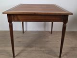 a wooden table with a drawer underneath it on a wooden floor