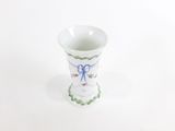a small white vase with a blue bow on it