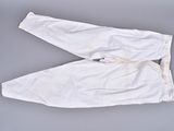 two pairs of white pants on a gray surface