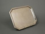 an antique silver tray with a mirror on top of it