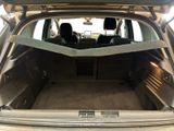 the back of a car with the trunk open and the seats folded down