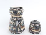 two vases sitting next to each other on a white surface