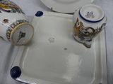 a white plate with blue trim and a blue and white cup and saucer on it