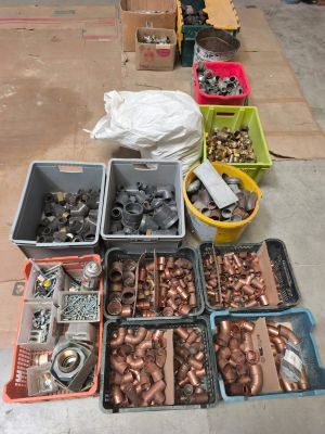 many different types of pipes and fittings on the floor