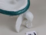 a figurine of a dog with a frisbee in its mouth