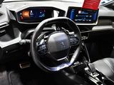 the interior of a car with a steering wheel, dashboard, and display screen