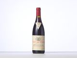 a bottle of red wine sitting on top of a table
