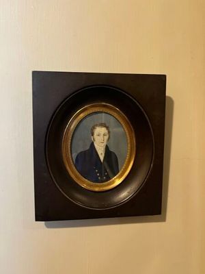 une photo encadrée représentant une femme vêtue d'un manteau bleu