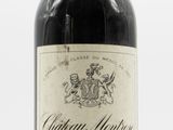 a close up of a bottle of wine on a white surface