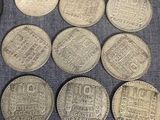 several different types of coins are on a blue cloth
