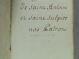 un livre ouvert avec une écriture dessus, posé sur une table