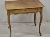 a small wooden table with a drawer on it