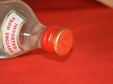 a bottle of liquor sitting on a red table