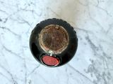 a bottle of wine sitting on a marble table
