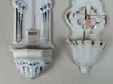 two wall sconces that are on the wall